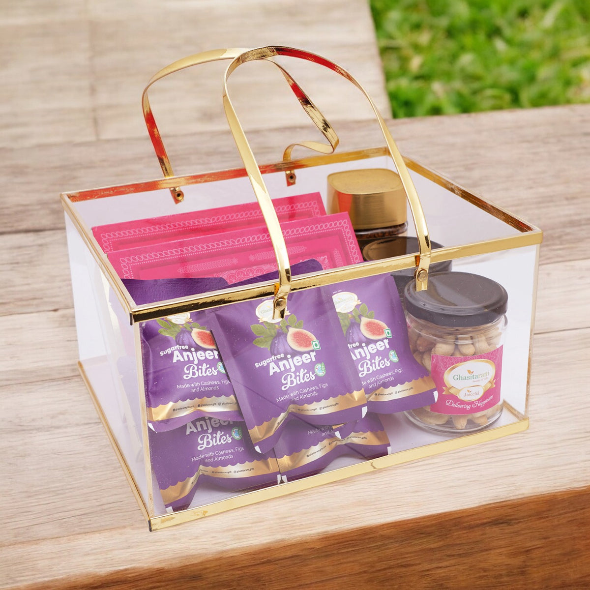 Acrylic Basket of Kaju Katli, Milk cake, 5 mewa bites, 2 jars of Roasted Cashews and Almonds, and Coffee