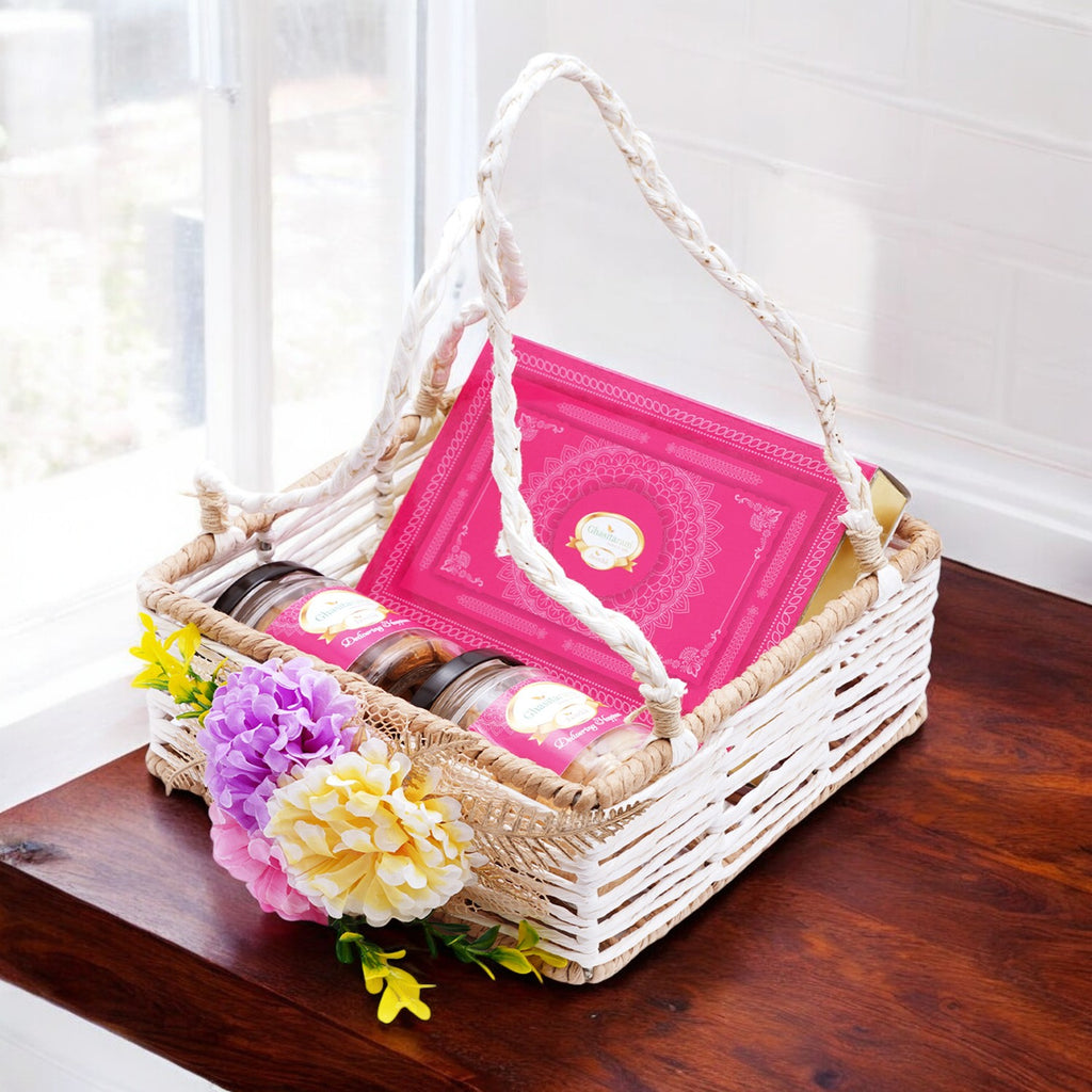 Jute Square Flower Basket with Kaju Katli and 2 Jars of Crunchy Cashews and Paan Raisins