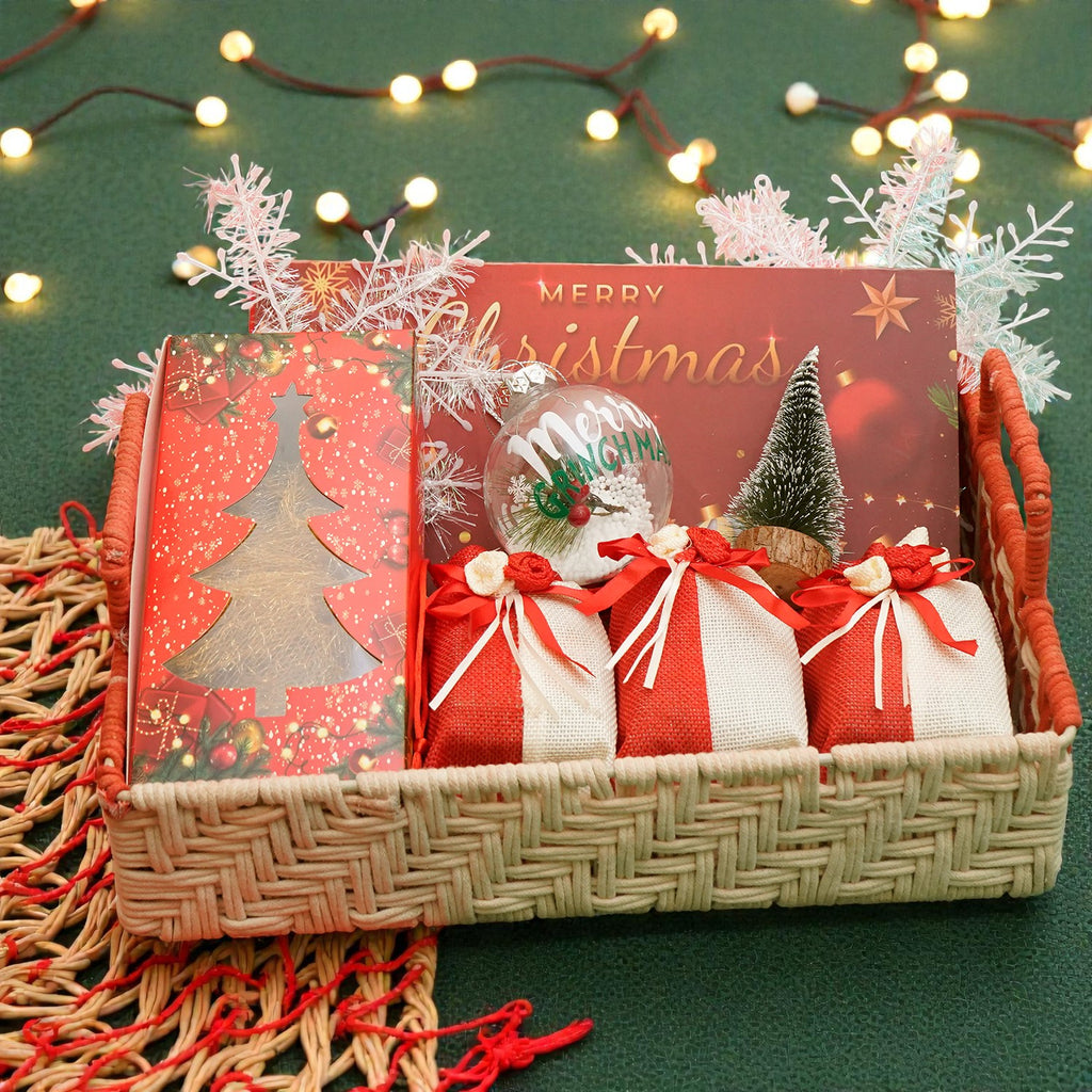 Rectangle Woven tray with plum cake, bites, chocolates, dry fruits and christmas décor
