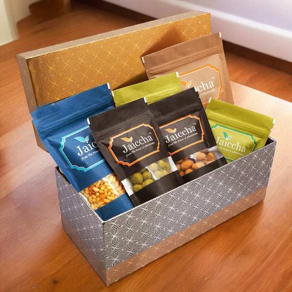 Rectangle box of Badang Bhel, Butter Chakli Sticks, Chocolate Coated Butterscotch, Chocolate Coated Raisins, Crunchy Coated Cashews and Crunchy Coated Peanuts
