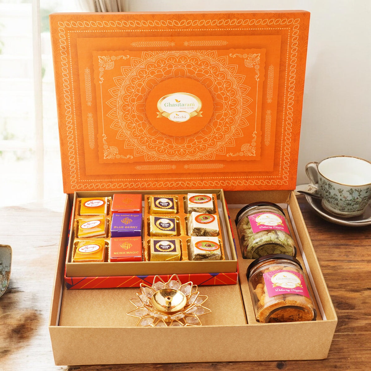 Orange Hamper box with best bites, crunchy cashew, Flavour raisins, and diya