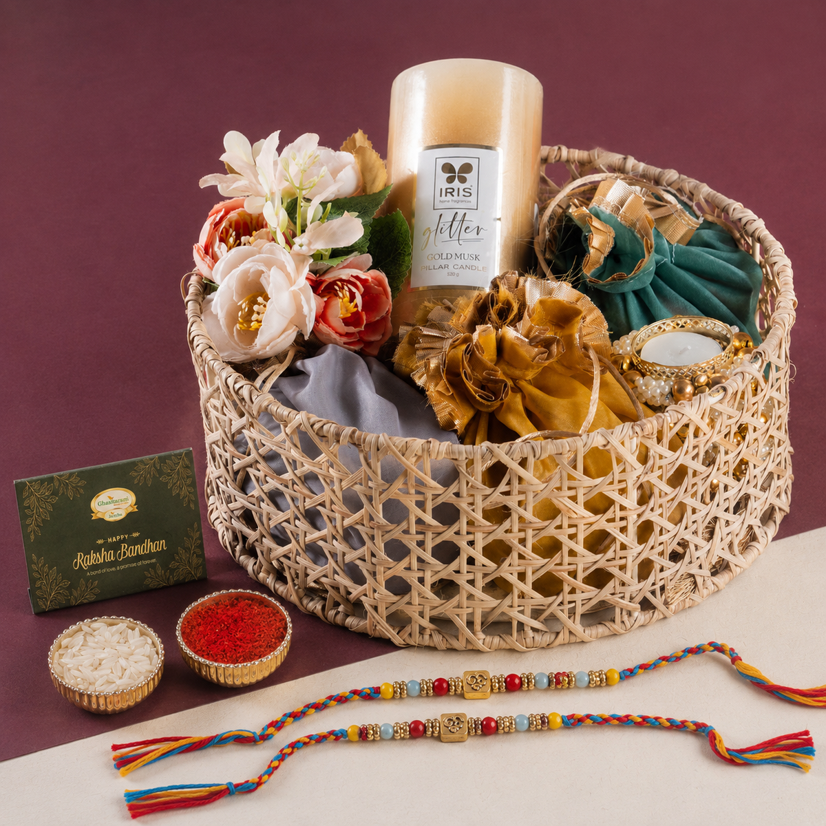 Round Rattan Basket with dryfruits, mithai Pouches, t Lites and Candle with 2 Rakhis
