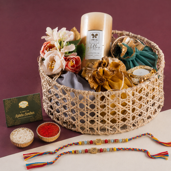 Round Rattan Basket with dryfruits, mithai Pouches, t Lites and Candle with 2 Rakhis