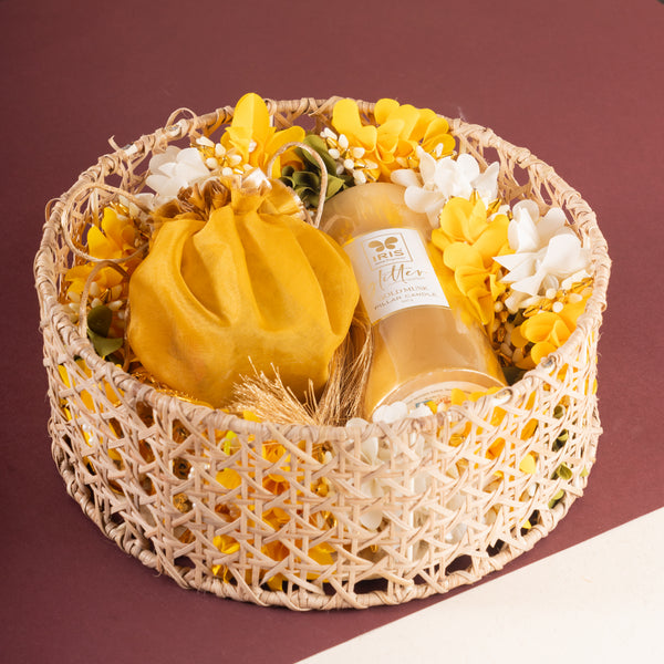 Diwali gifts-Round Rattan Basket with toran, dryfruits, and a candle.