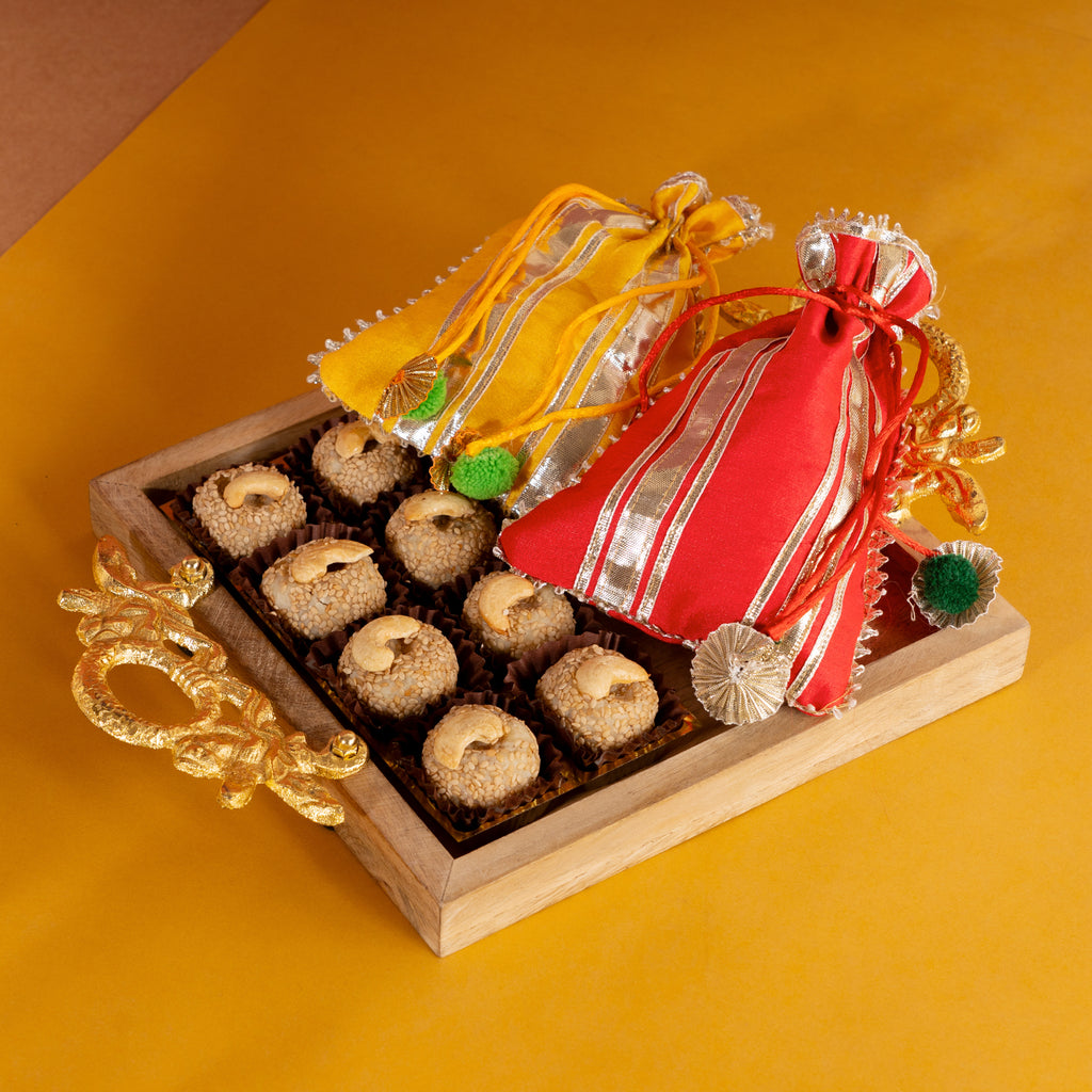 Square Wooden Tray of Til Laddoo, Revadi and Til Almonds, in Gota Pouches