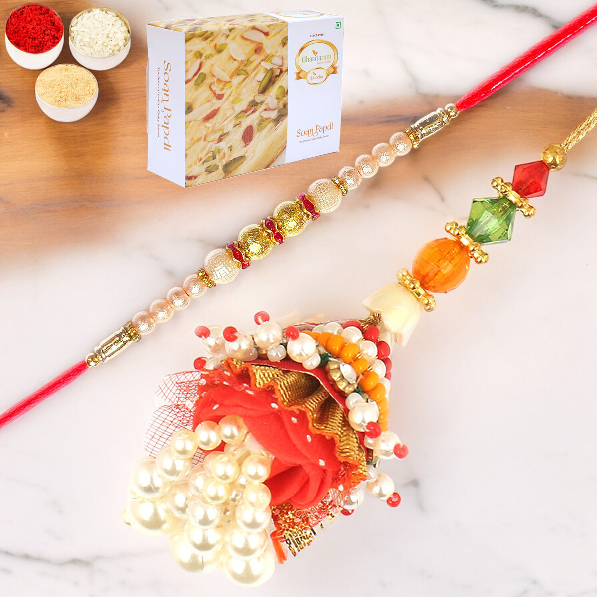 Rakhis Online UK- Enticer of Faith Bhaiya Bhabhi rakhi with 200 gms Soan Papdi