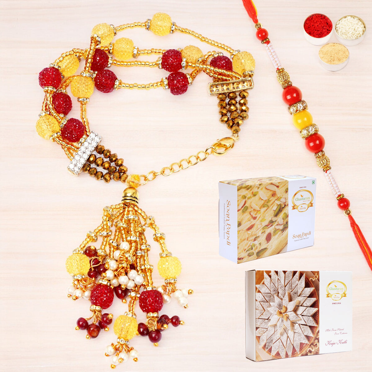Rakhis Online-RM-205 Bhaiya Bhabhi Rakhi with 200 gms of Kaju katli and 200 gms of Soan Papdi