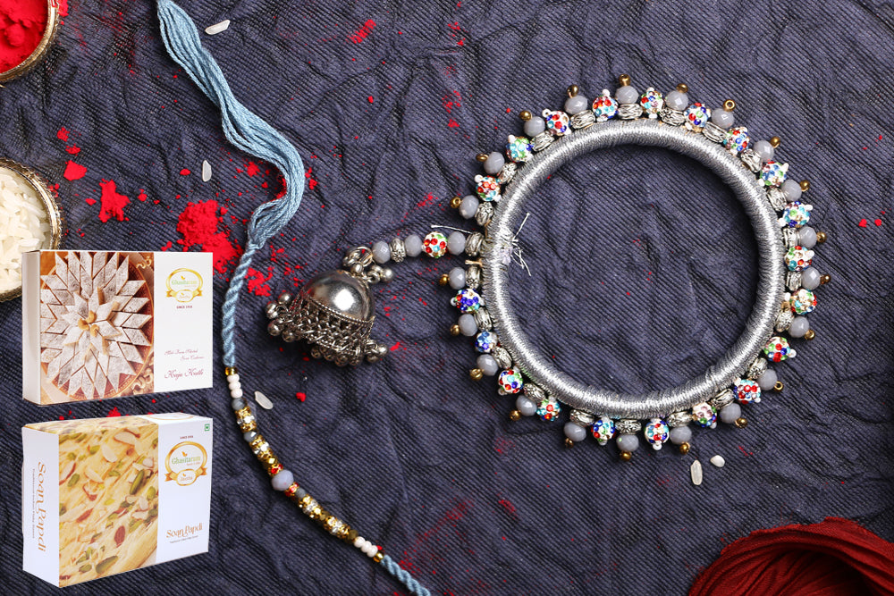 Rakhis Online-RM-262 Bhaiya Bhabhi Rakhi with 200 gms of Kaju katli and 200 gms of Soan Papdi