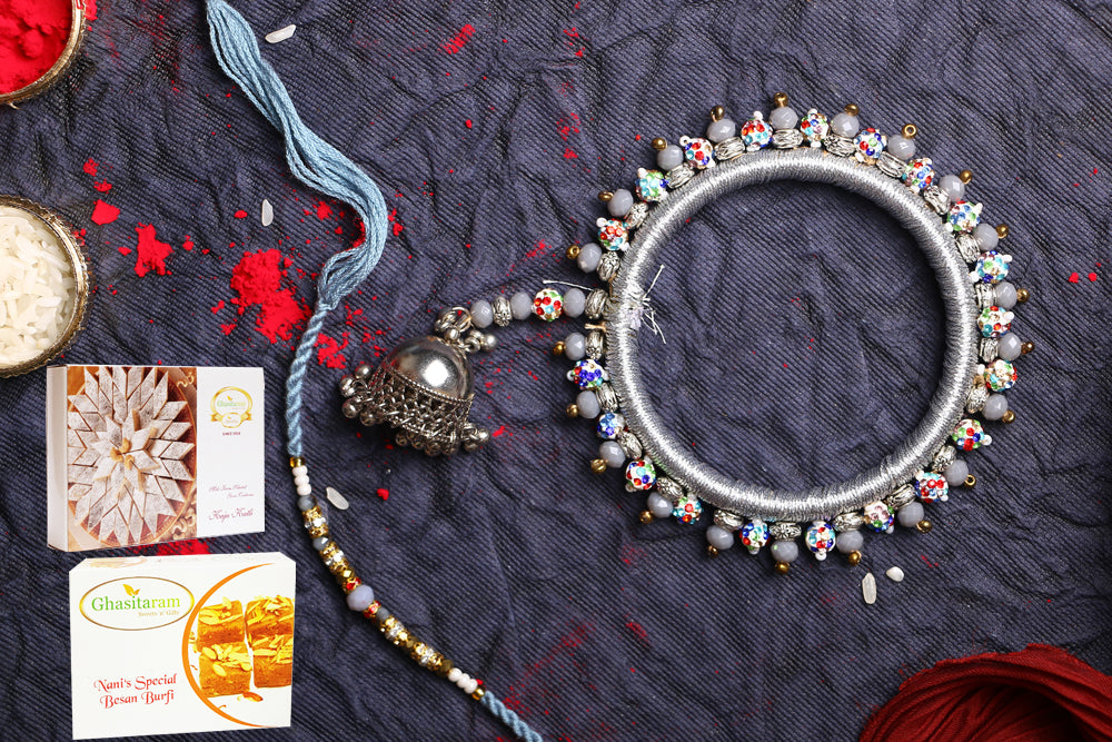 Rakhis Online-RM-262 Bhaiya Bhabhi Rakhi with 200 gms of Besan Barfi and 200 gms of Kaju Katli
