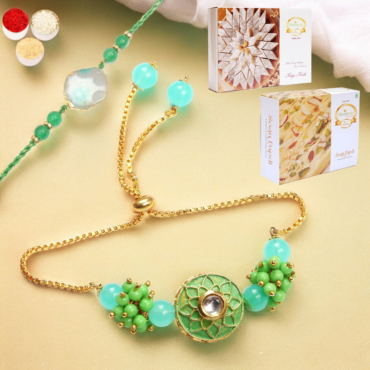 Rakhis Online-T-12 Green Stone Bhaiya Bhabhi Rakhi with 200 gms of Kaju katli and 200 gms of Soan Papdi