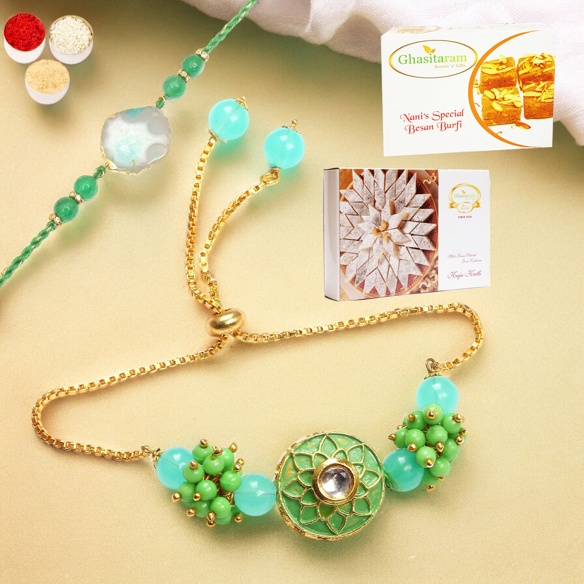 Rakhis Online-T-12 Green Stone Bhaiya Bhabhi Rakhi with 200 gms of Besan Barfi and 200 gms of Kaju Katli