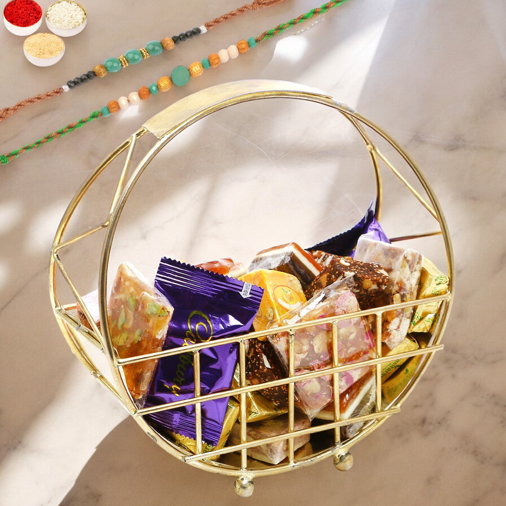 Rakhi Gifts-Half Moon Metal Basket of Bites, Chikki and Cookies With 2 Green Beads Rakhis