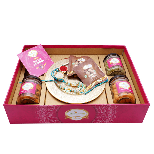 Ghasitaram Big Hamper Tray with Gold Pooja Thali, Bhaiya Bhabhi Rakhis, Card, Mewa Bites , Mixed Dryfruit Jar, Paan Raisins and Crunchy Cashews.