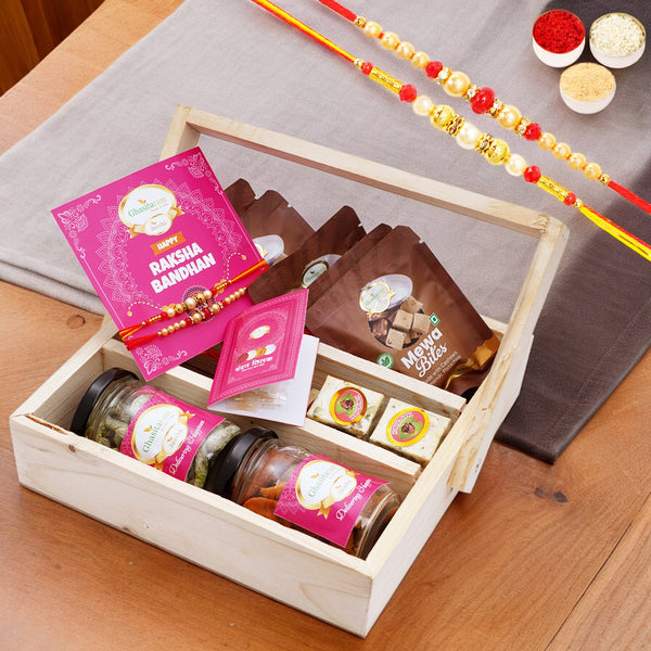 5 part wooden tray with mewa bites, 2 rakhis, Card, Paan crunch Bites, 2 jars of Mixed Dryfuit, and Paan Raisins with 2 Rakhis