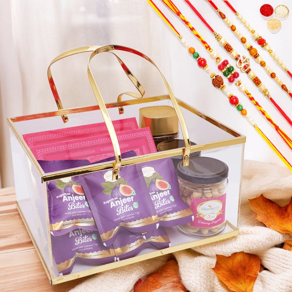 Acrylic Basket of Sugarfree Kaju Katli, Sugarfree Peda, 5 Sugarfree bites, 2 jars of Roasted Cashews and Almonds, and Coffee with 5 Rakhis