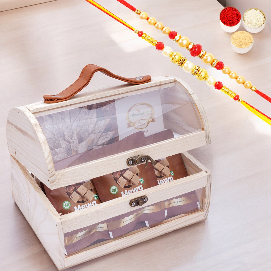 Acrylic Trunk Box with Kaju Katli and 5 Mewa Bites with 2 Rakhis