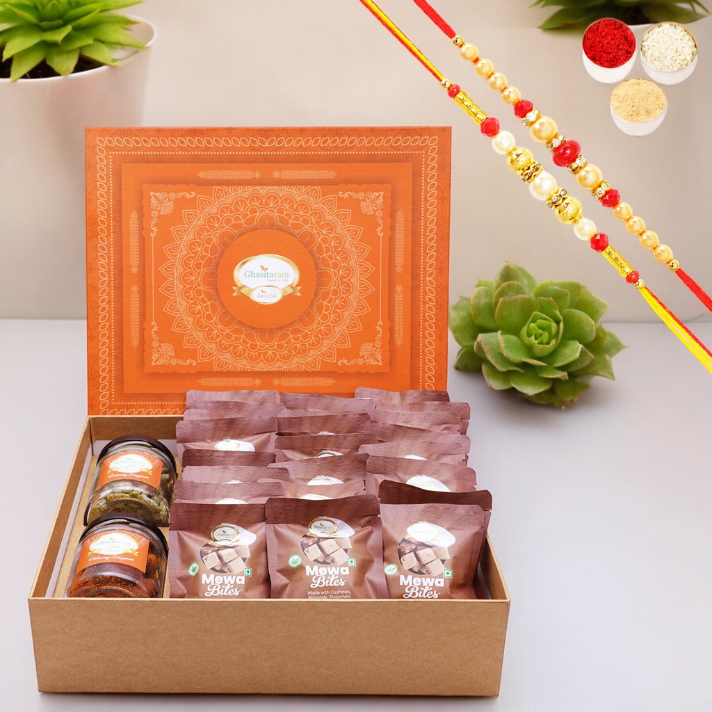 Ghasitaram Orange Hamper Box of  24 pcs mewa bites, Mixed Dryfruit Jar and Paan Raisins Jar with 2 Rakhis