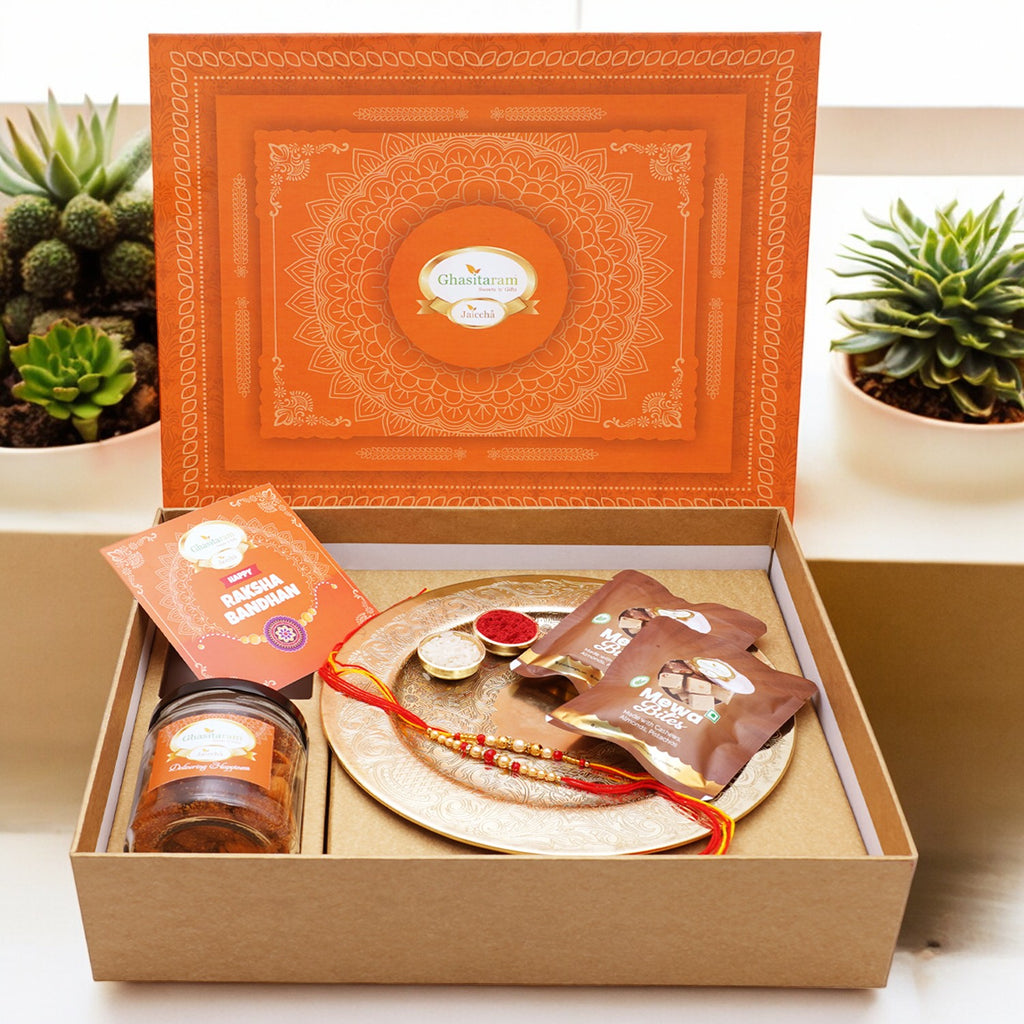 Ghasitaram Orange Hamper Box with Gold Pooja Thali,  2 rakhis, Card, Mewa Bites Pouches and Mixed Dryfruit Jar