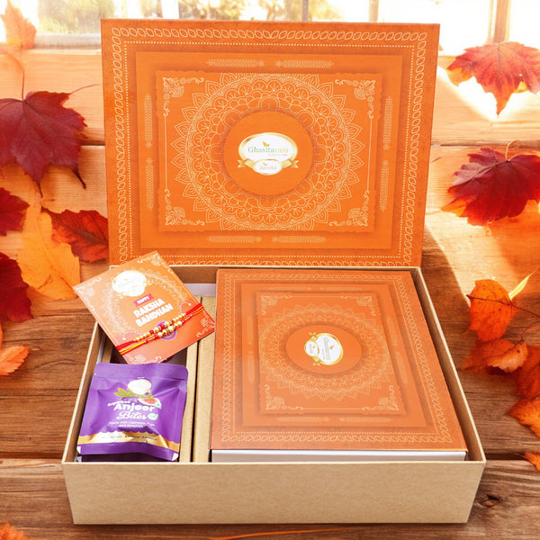 Ghasitaram Orange Hamper Box with Sugarfree Kaju Katli, 2 rakhis, Card, and Anjeer Bites