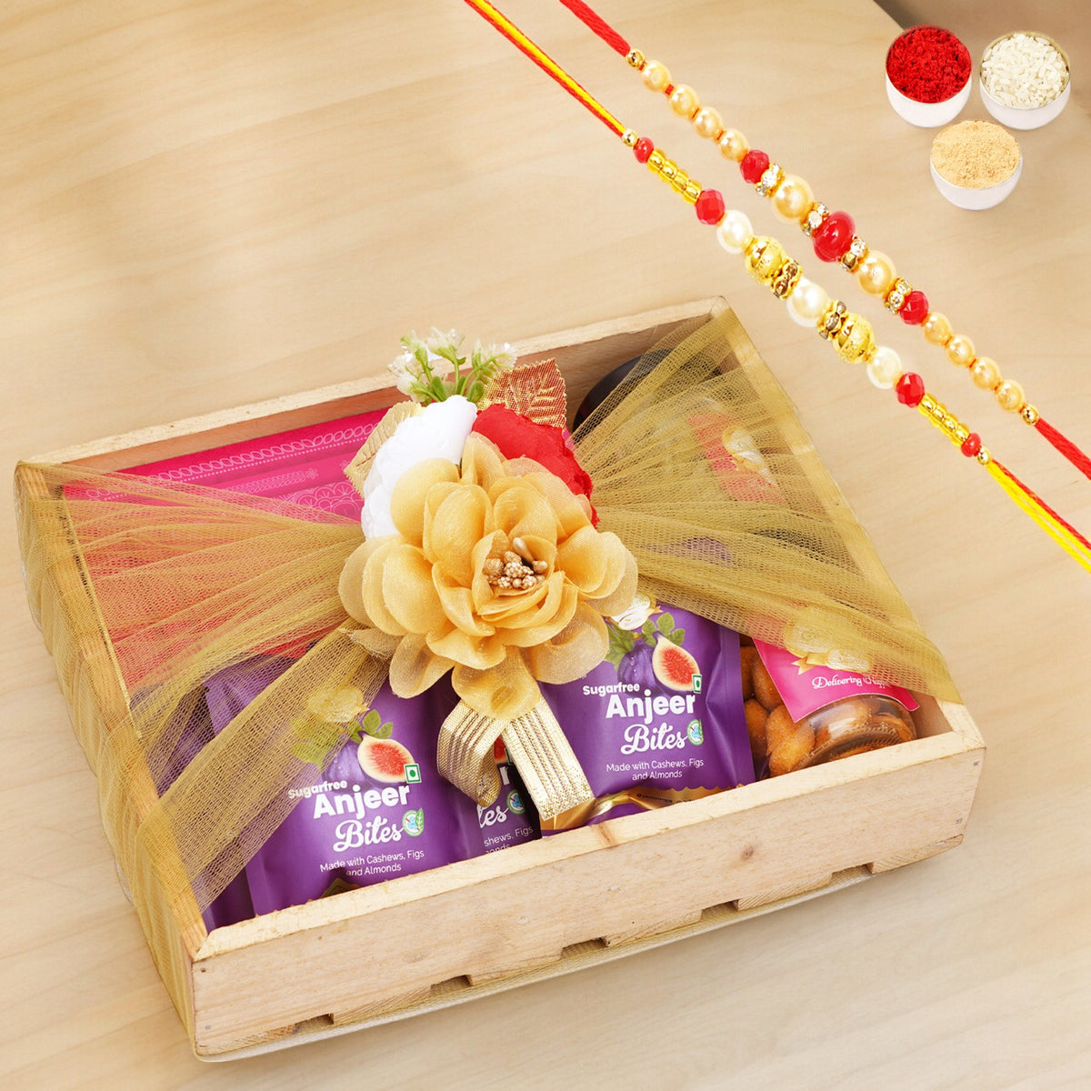 Wooden tray of Sugarfree Kaju Katli, 5 Sugarfree Bites and 2 Jars of Paan Raisins and Crunchy Cashews with 2 Rakhis