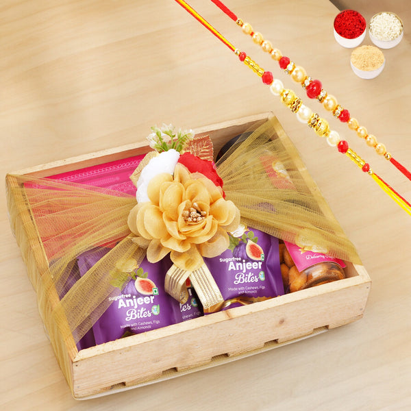 Wooden tray of Sugarfree Kaju Katli, 5 Sugarfree Bites and 2 Jars of Paan Raisins and Crunchy Cashews with 2 Rakhis