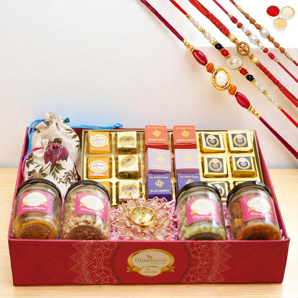 Big Pink tray of best bites, jute pouches of mewa bites and anjeer bites, 2 jars of dryfruits, 2 jars of namkeen and diya with 5 rakhis