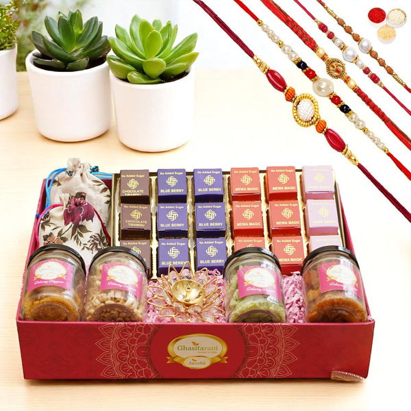 Big Pink tray of Sugarfree bites, jute pouches of mewa bites and anjeer bites, 2 jars of dryfruits, 2 jars of namkeen and diya with 5 rakhis