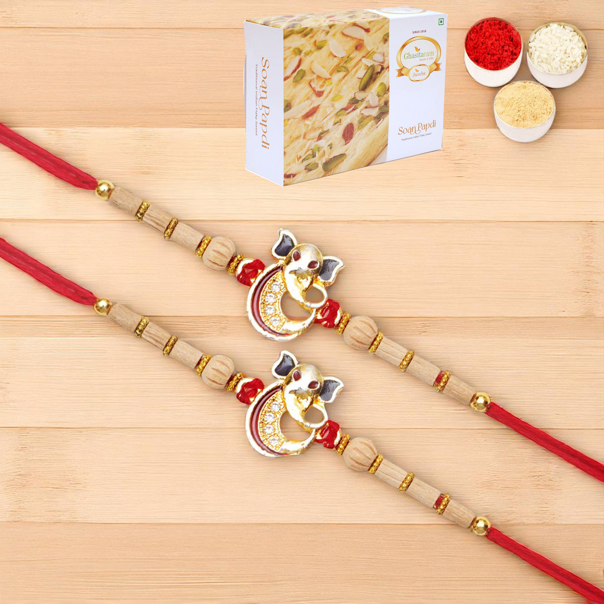 Rakhis Online USA-Set of 2 - A-2 Ganesha Divine Rakhi with 200 gms of Soan Papdi