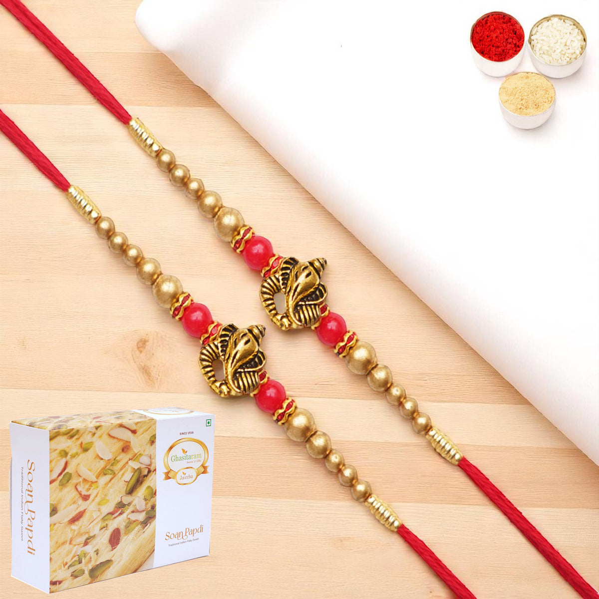 Rakhis Online UK-Set of 2 - Y-26 Ganesha divine Rakhi with 200 gms of Soan Papdi