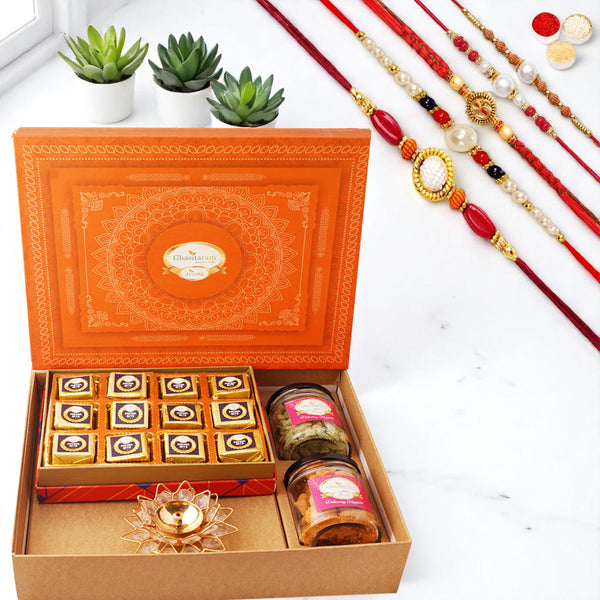 Orange Hamper box with best bites, crunchy cashew, Flavour raisins, and diya with 5 rakhis