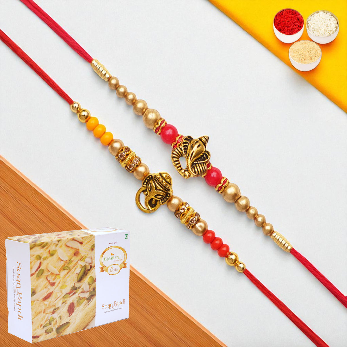 Rakhis Online USA-Set of 2 y26 and y58 om ganesh divine rakhis with 200 gms of Soan Papdi