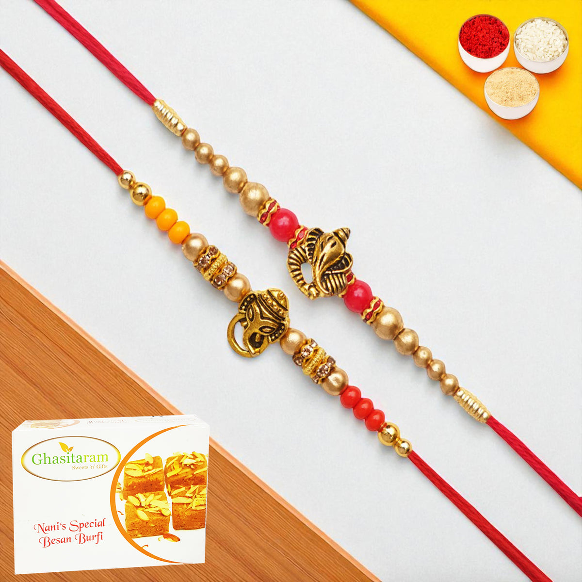 Rakhis Online USA-Set of 2 y26 and y58 om ganesh divine rakhis with 200 gms of Besan Barfi