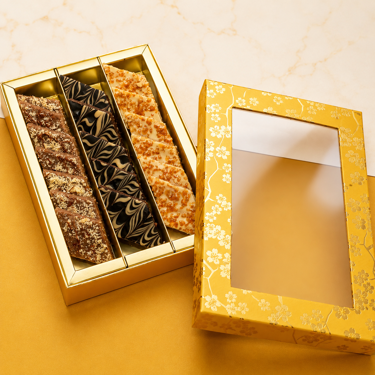 Gift box of hazelnut katli, caramel katlis, and chocolate kaju katlis/ Fusion Sweets