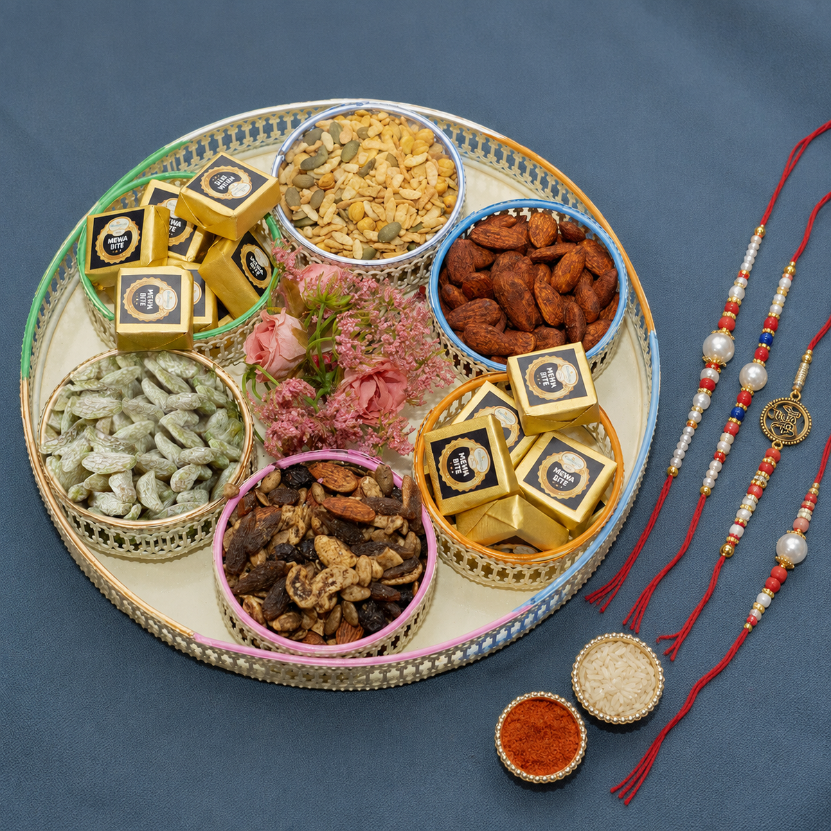White Platter of Mewa bites, Quinoa snack and Dryfruit with 2 Om Premium Rakhis
