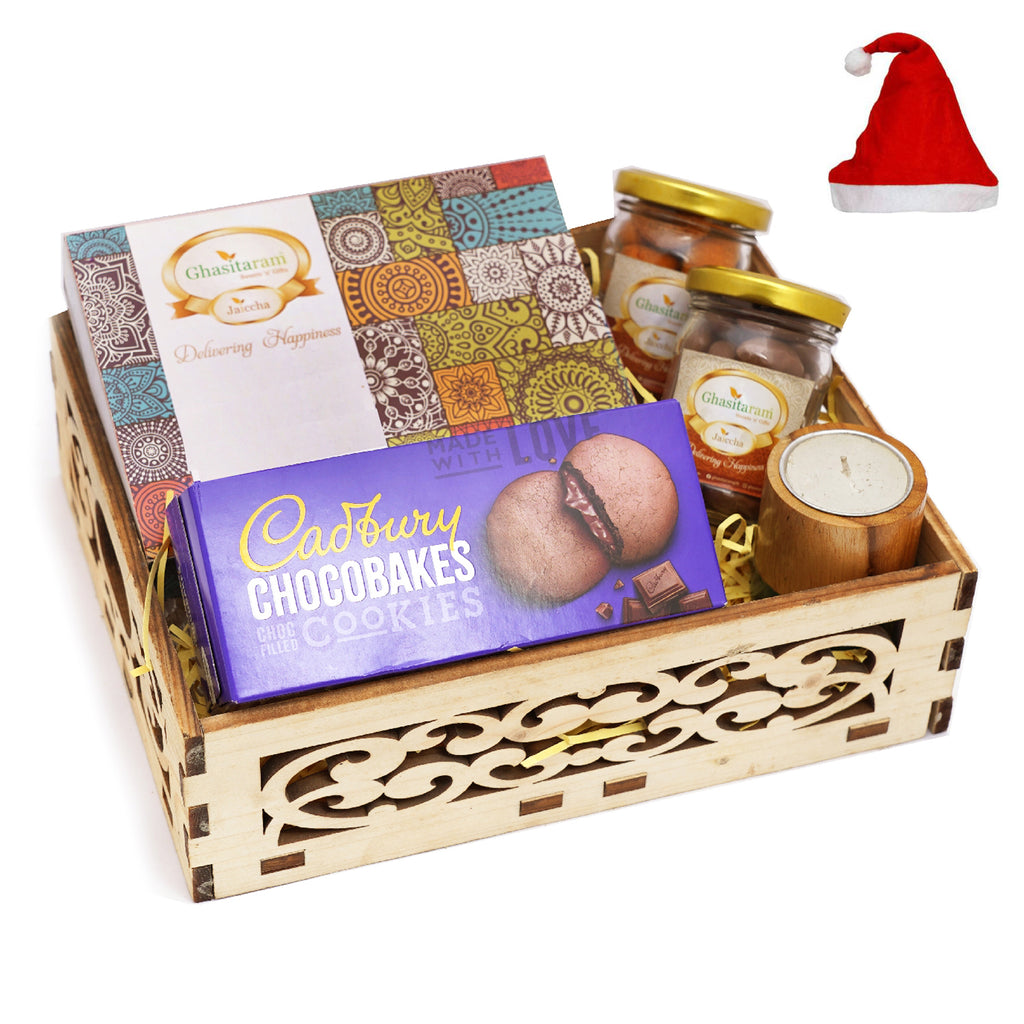 Wooden Carved Basket of Assorted Bites, a pack of Chocobakes, Chocolate Caoted Almonds Jars, Crunchy Coated Cashews, and a Long Wooden Long T-Lite.