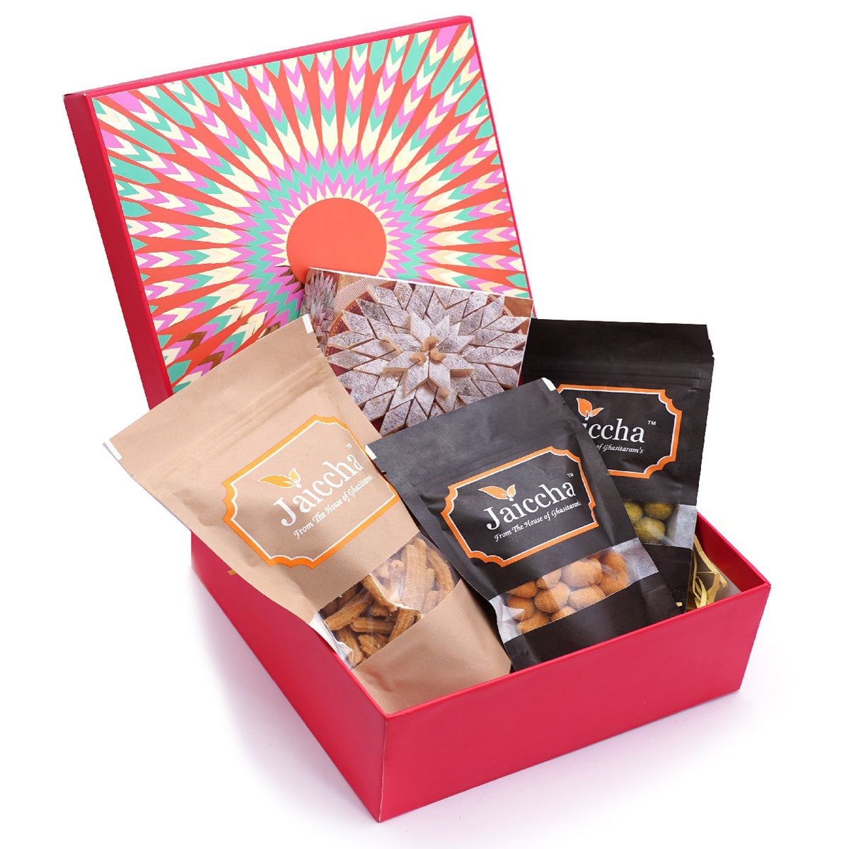 Red hamper box of Kaju Katlis, Crunchy Coated Cashews, Crunchy Coated Peanuts, Butter Chakli Sticks