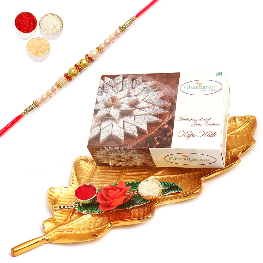 Golden Leaf platter With Kaju Katli and Green Leaf Roli Chawal Container with Pearl Rakhi