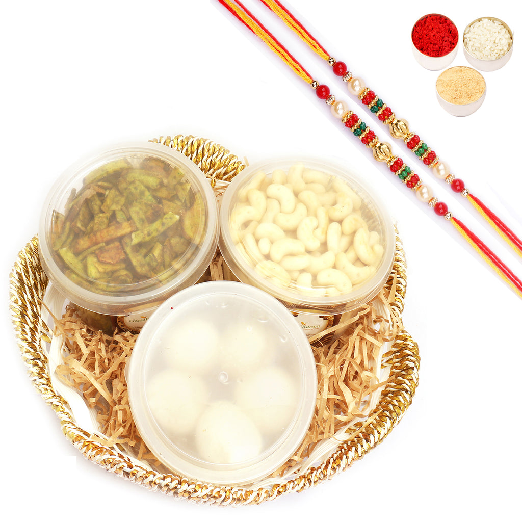Round White Basket of Rasgulla,Palak Chips and Cashew Shaped Biscuits with 2 Pearl beads rakhi