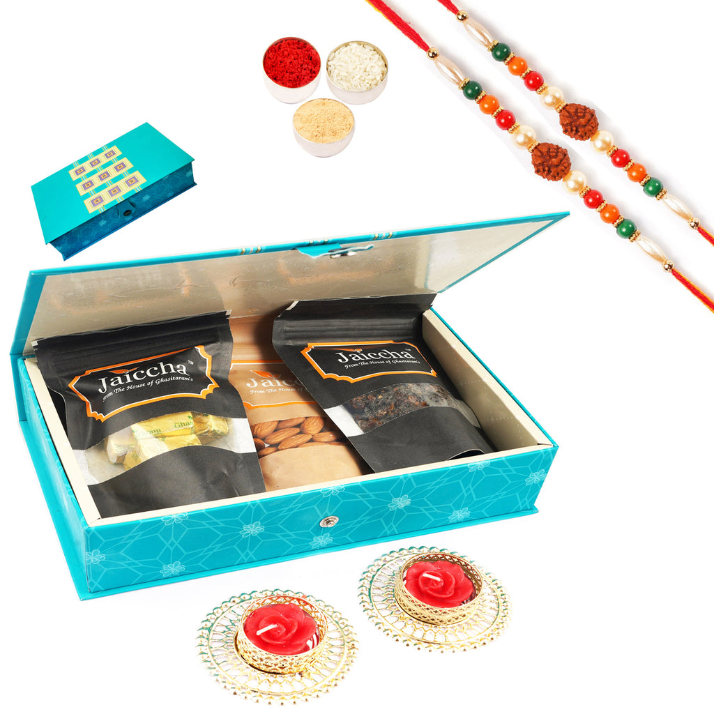 Blue Rectangular box of Mewa Bites, Almonds,Banarsi Paan and 2 T-Lites with 2 Rudraksh Rakhis