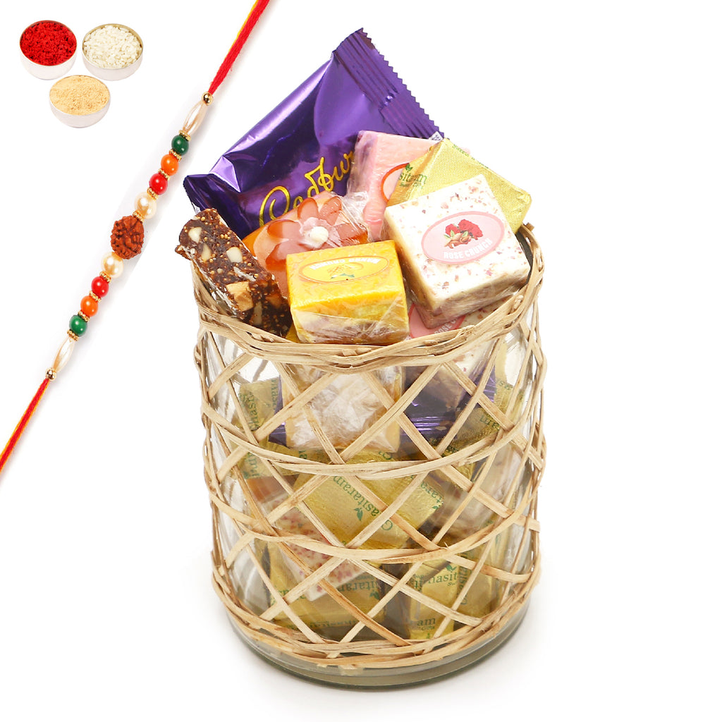 Rakhi Gifts-Cane Glass Jar with Assorted Bites, Laddoos and Cookies With rudraksh rakhi